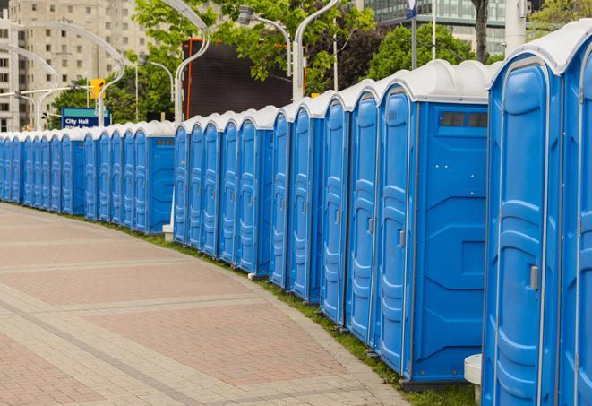 a row of portable restrooms set up for a large athletic event, allowing participants and spectators to easily take care of their needs in Bluemont